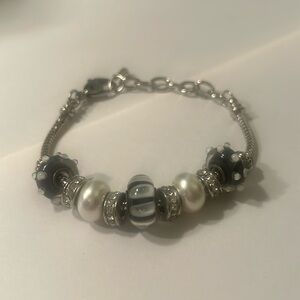 Silver tone charm bracelet w/ black & white and silver tone w/ rhinestones beads